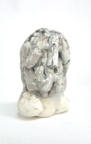 Miniature ceramic sculpture of a woman in grey tones