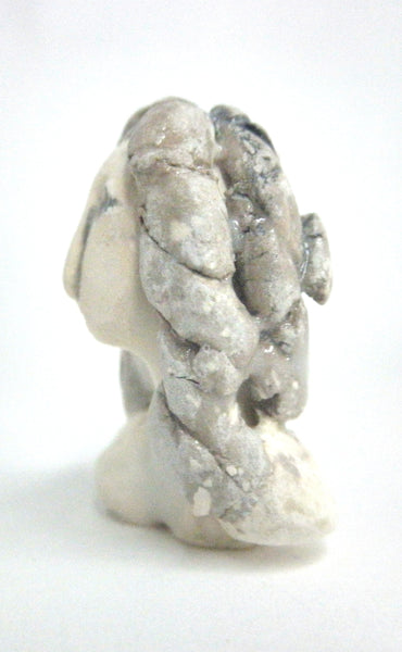 Miniature ceramic sculpture of a woman in grey tones