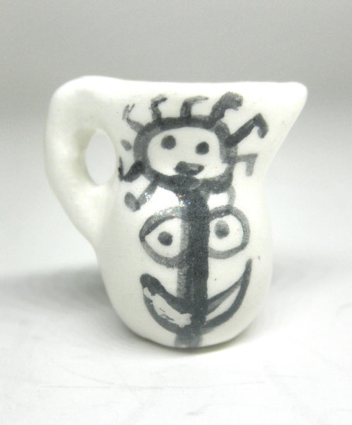 Miniature Picasso inspired ceramic pitcher - stylized woman on white.