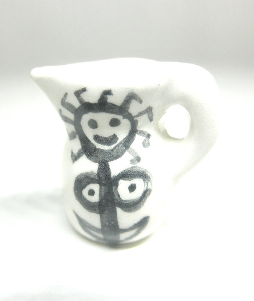 Miniature Picasso inspired ceramic pitcher - stylized woman on white.