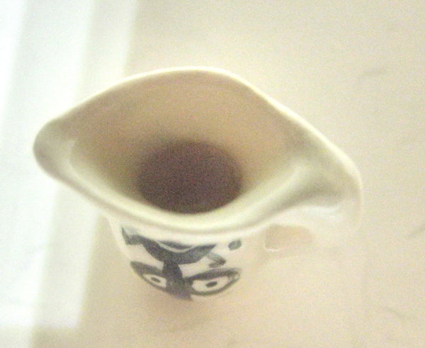 Miniature Picasso inspired ceramic pitcher - stylized woman on white.