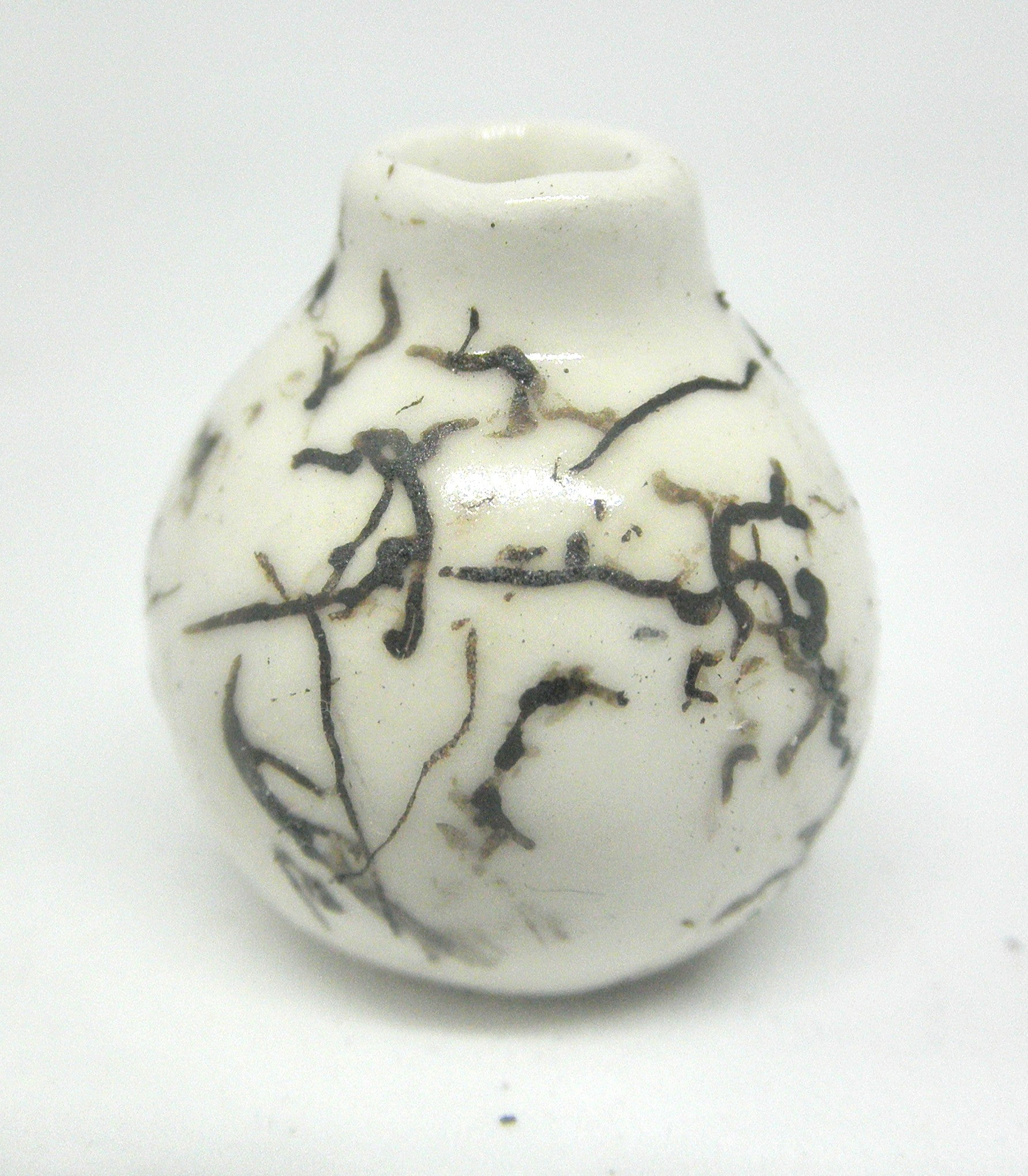 Miniature ceramic small vase with hair decoration.