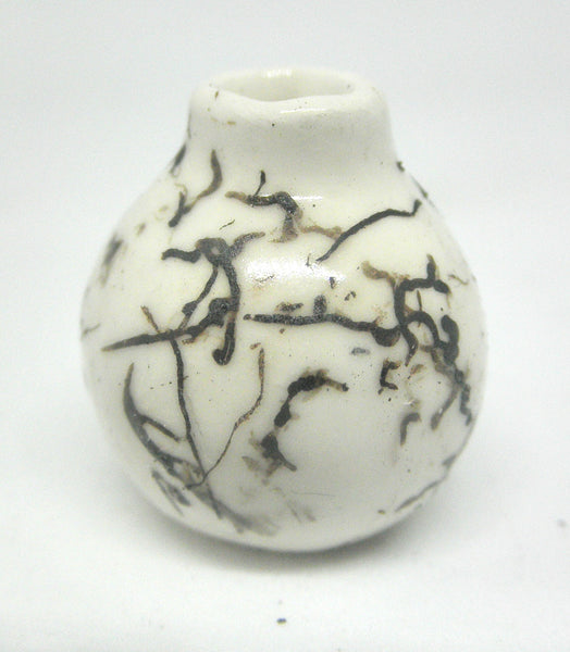 Miniature ceramic small vase with hair decoration.