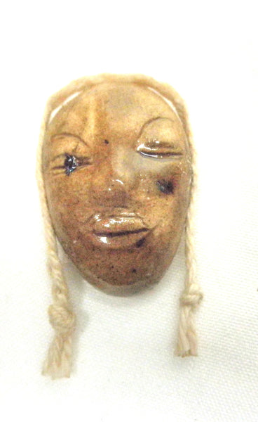 Miniature African art mask with braid