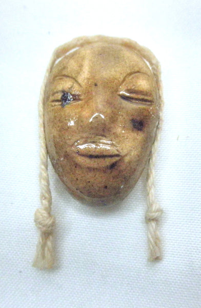 Miniature African art mask with braid