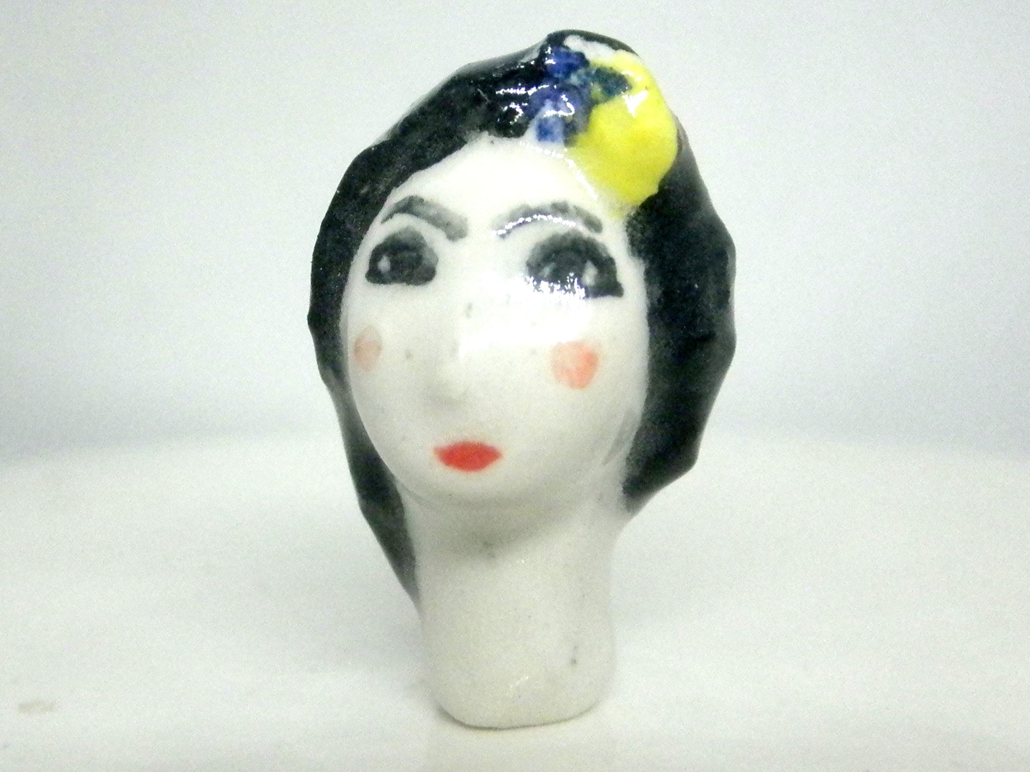 Miniature collector's figurine woman with white face
