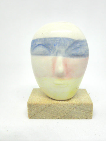 Miniature ceramic collector's head with pastels