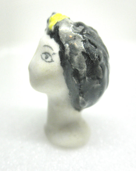 Miniature collector's figurine woman with white face