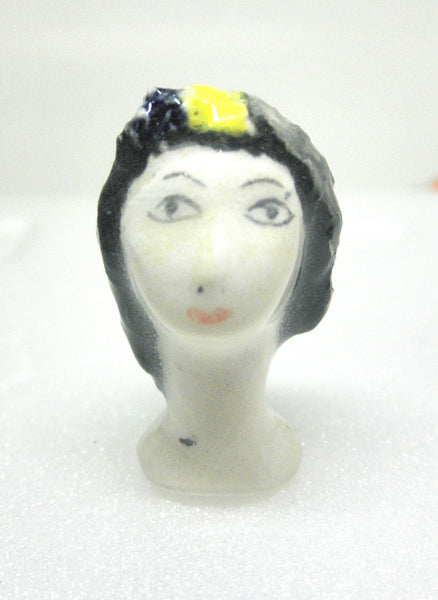 Miniature collector's figurine woman with white face