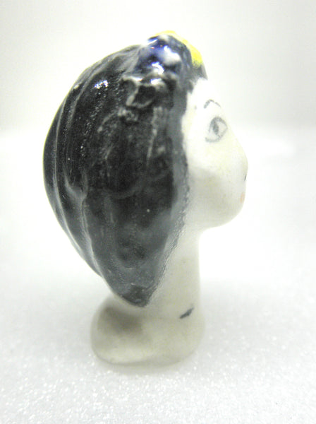 Miniature collector's figurine woman with white face