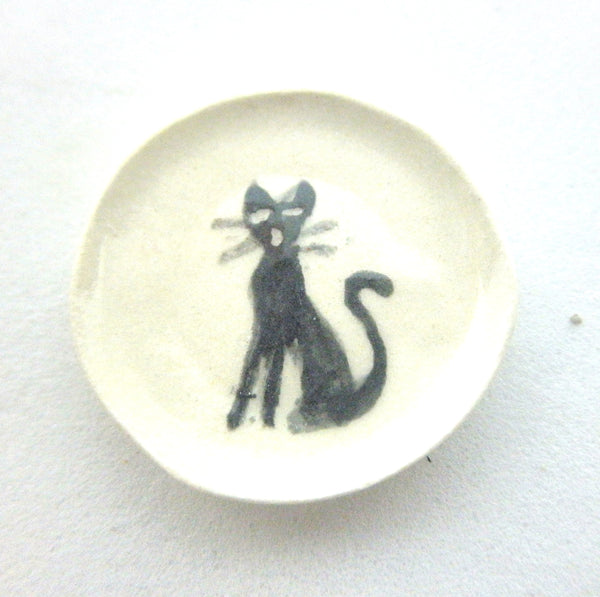 Miniature ceramic plate with sitting black cat