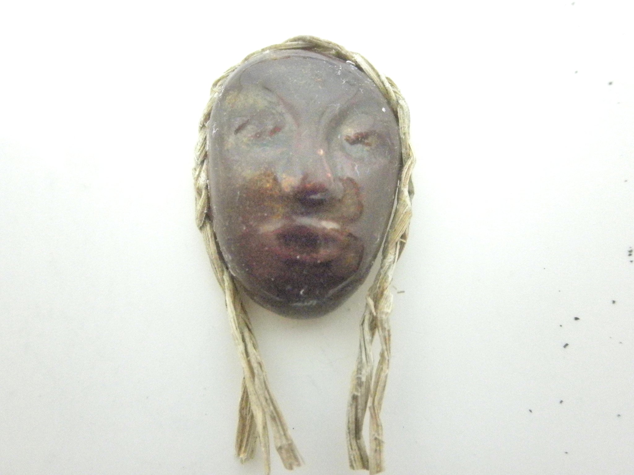 Miniature African art mask with braid