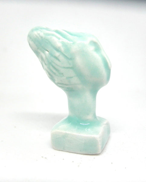 Miniature ceramic collector sculpture of a woman with sweeping hair