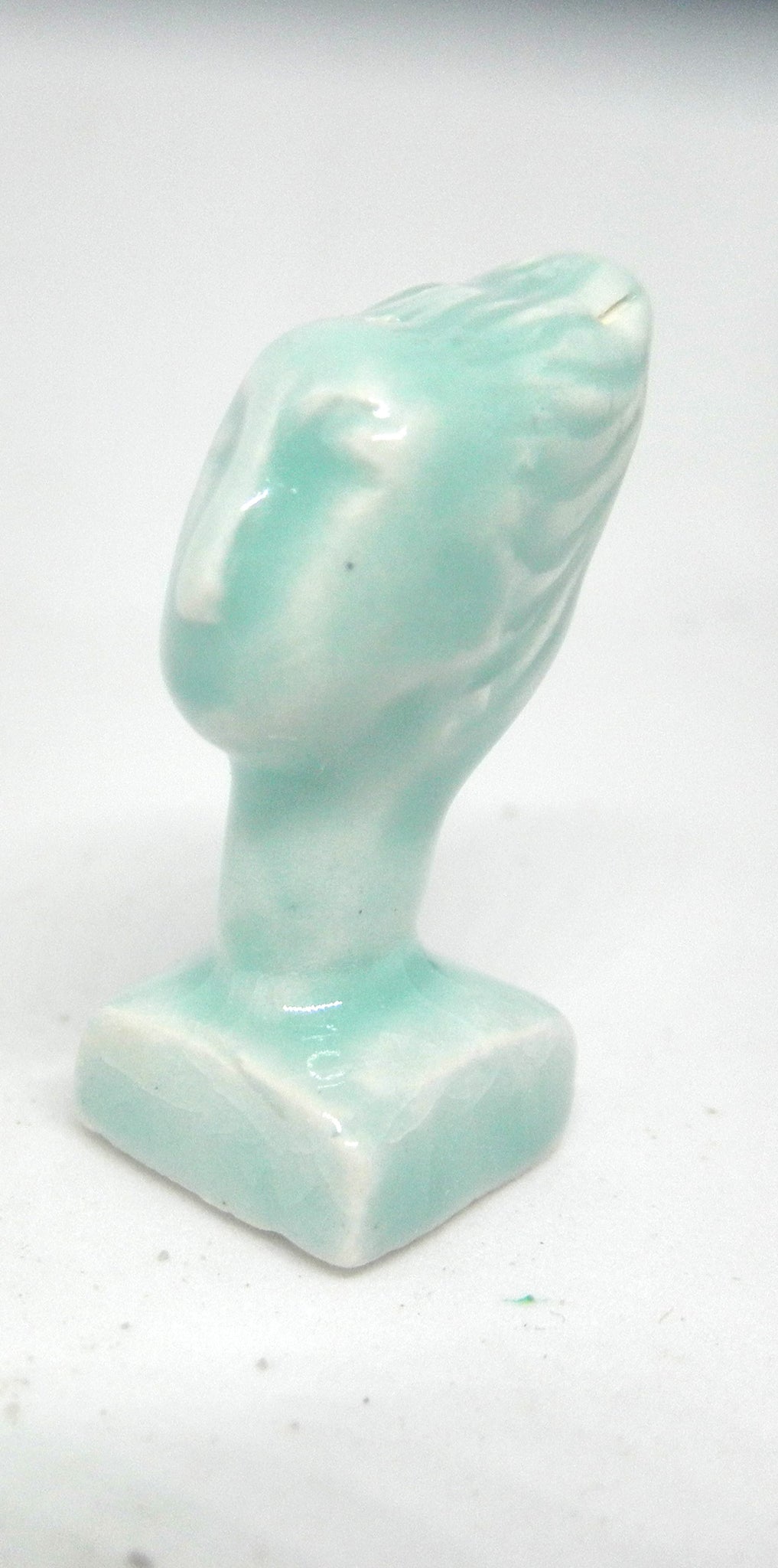 Miniature ceramic collector sculpture of a woman with sweeping hair