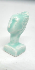 Miniature ceramic collector sculpture of a woman with sweeping hair