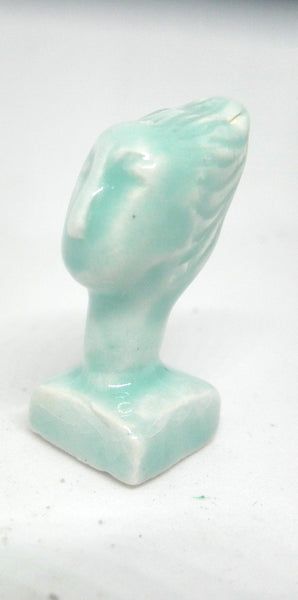 Miniature ceramic collector sculpture of a woman with sweeping hair