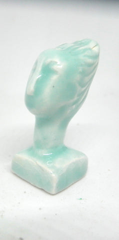 Miniature ceramic collector sculpture of a woman with sweeping hair