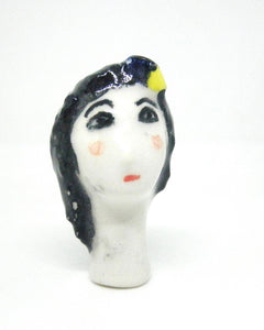 Miniature collector's figurine woman with white face