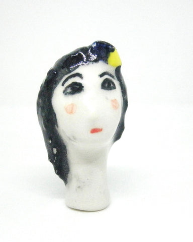 Miniature collector's figurine woman with white face