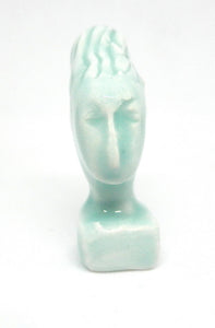 Miniature ceramic collector sculpture of a woman with sweeping hair