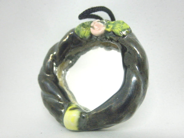 Miniature mirror with black ceramic frame and a rose