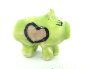 Miniature ceramic piggy bank - green with pink hearts
