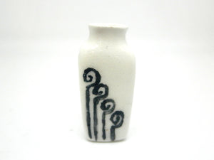 Miniature modern ceramic vase with stylized fern fronds.